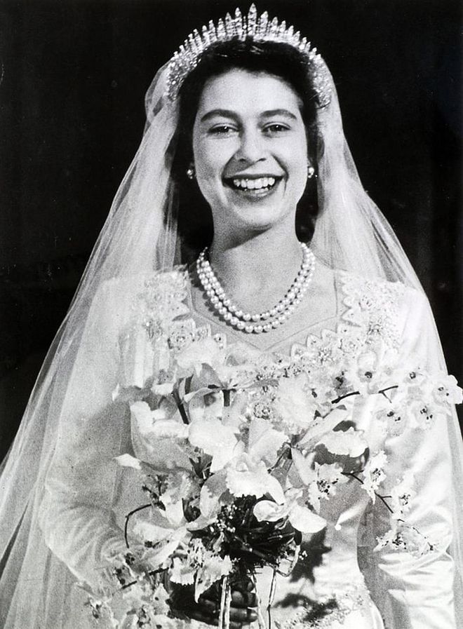 Queen Elizabeth wore Queen Mary's Russian Fringe tiara on her wedding day. The piece of jewelry was made for Queen Mary, the grandmother of Queen Elizabeth, in 1919 and can be worn as a necklace or atop the head. Elizabeth's tiara famously broke on her wedding day, but was quickly repaired.