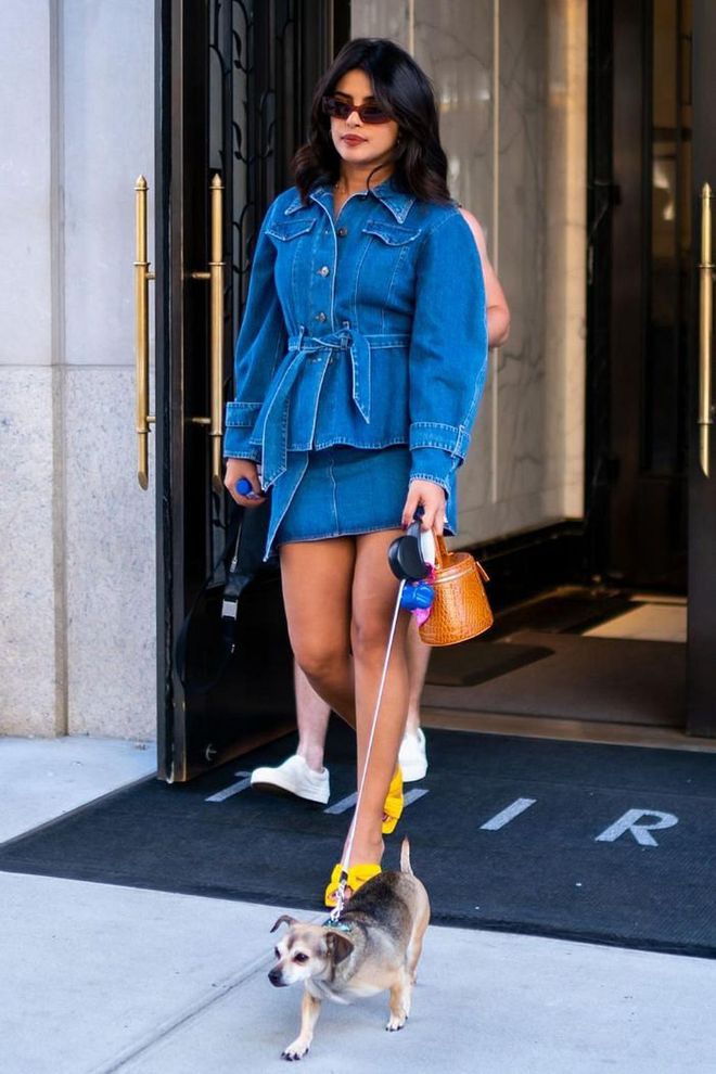 In a belted denim jacket and matching skirt while walking her dog in New York.

Photo: Getty