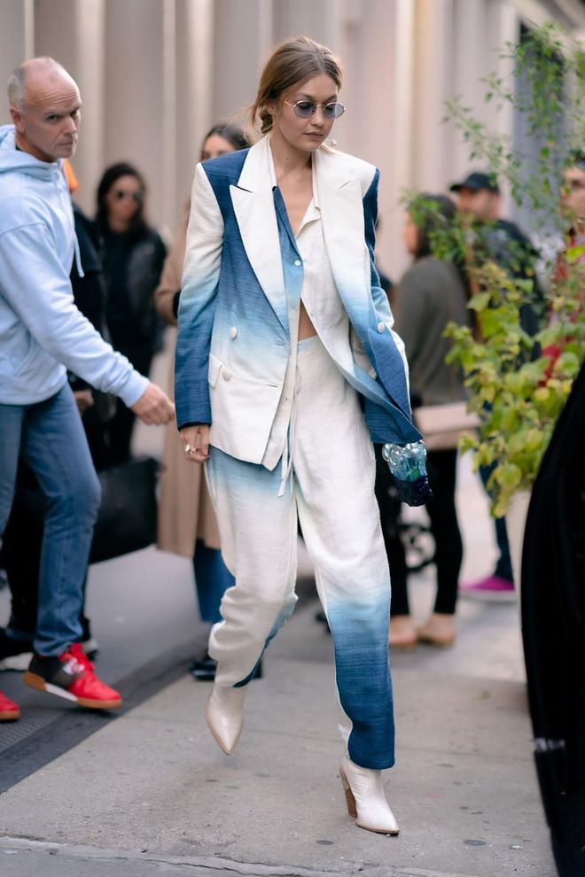 Gigi Hadid looked fresh in a blue and white suit by Oscar de la Renta paired with white heeled boots.