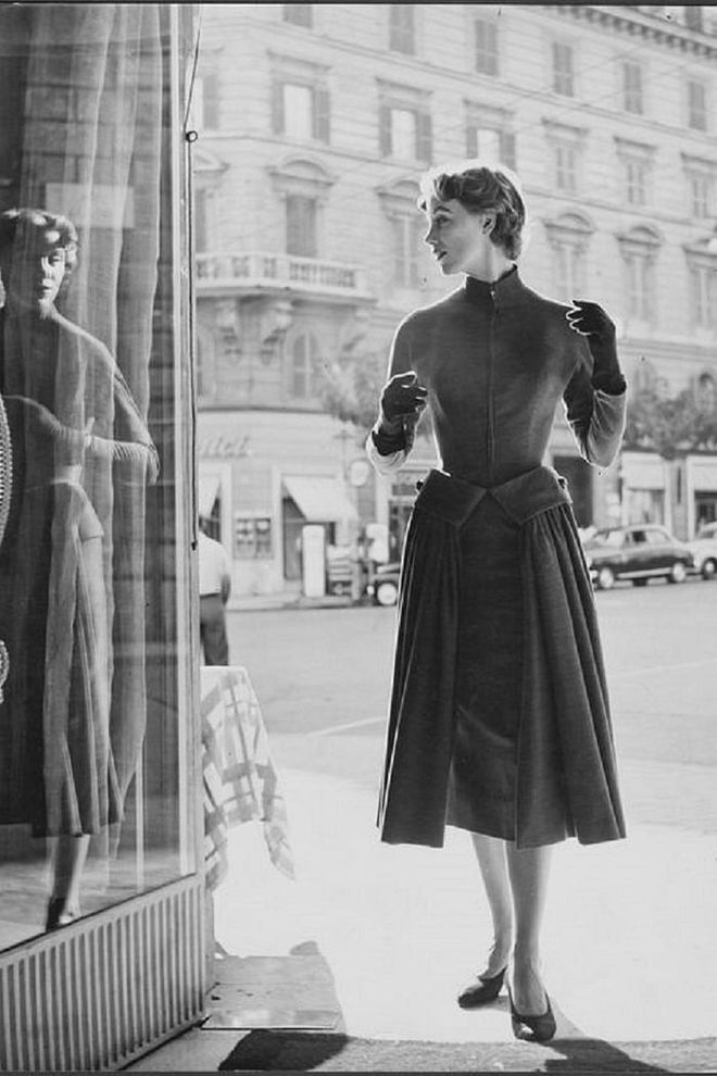 A model wearing a high-neck dress and gloves.

Photo: Getty