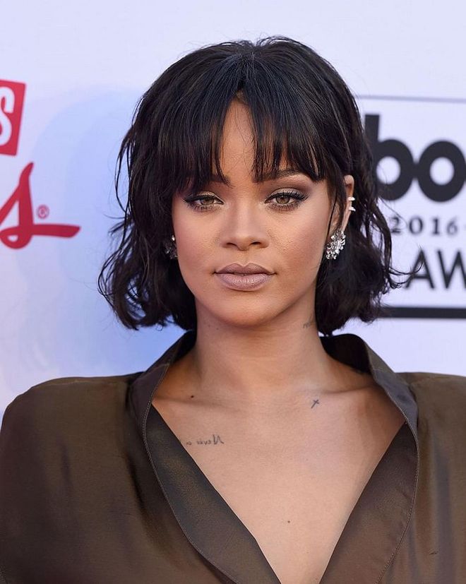 The bold RiRi take on the bob involves midnight black strands and thick, in-your-face bangs. 