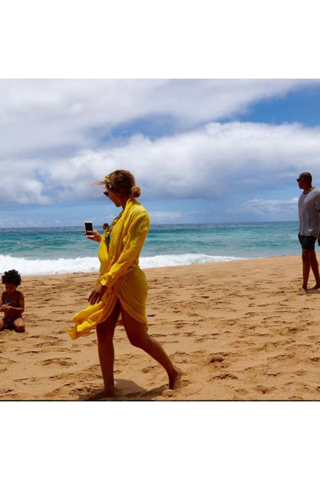 Queen Bey took her Lemonade album to the beach in a bright yellow coverup and a headband made of mini lemons while vacationing with Jay Z and Blue. —@Beyonce Photo: Instagram