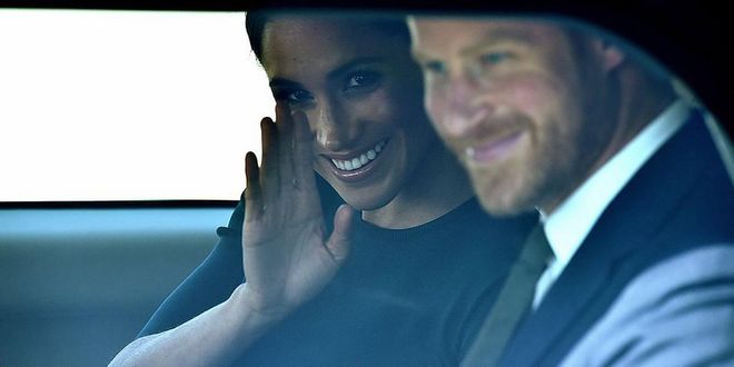 Markle sneaks a wave from inside her car.

Photo: Getty