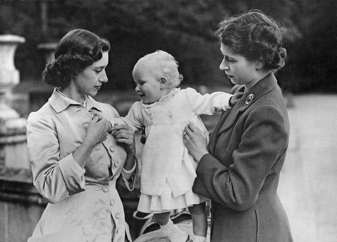 A royal aunt! Margaret and Elizabeth play with a young Princess Anne at Balmoral Castle in Scotland.
Photo: Getty 