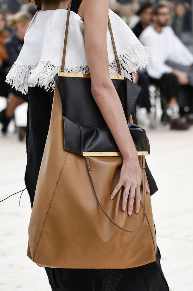 Seen at: Paris Fashion Week//Why we love it:  Céline gives a whole new meaning to "effortless chic" with a huge slouchy leather tote accented with golden details, carried casually with its opening wide agape. (Photo: Getty)