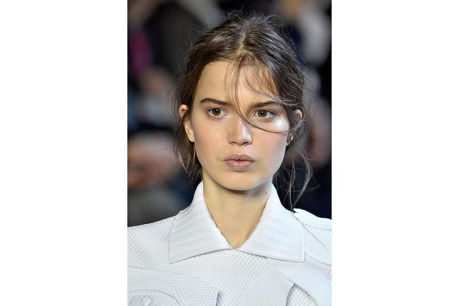 Washes of iridescent colour across the eyes and cheekbones with undone, flyaway hair created a pretty, ethereal look at Viktor & Rolf ; Photo: Getty