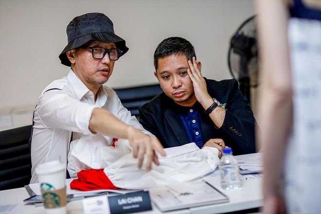 Renowned fashion designer Lai Chan and Christopher Daguimol, Group Director - Public Relations & Social Media at ZALORA, discussing a contestant's collection.