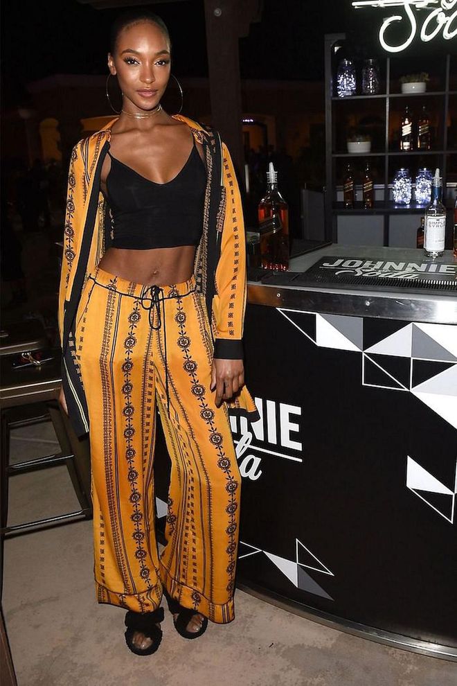 Double up on print and color with coordinated separates broken up by a black crop top and slides.

Photo: Getty