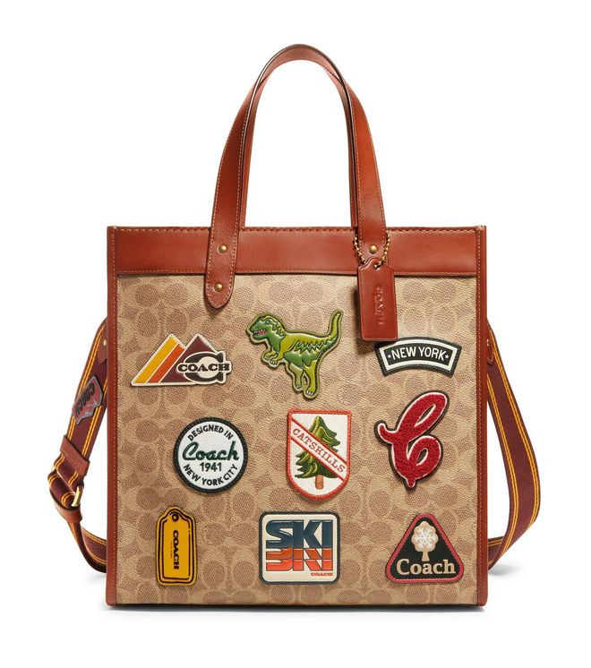 Field Tote In Signature Canvas With Patches, $950. Coach