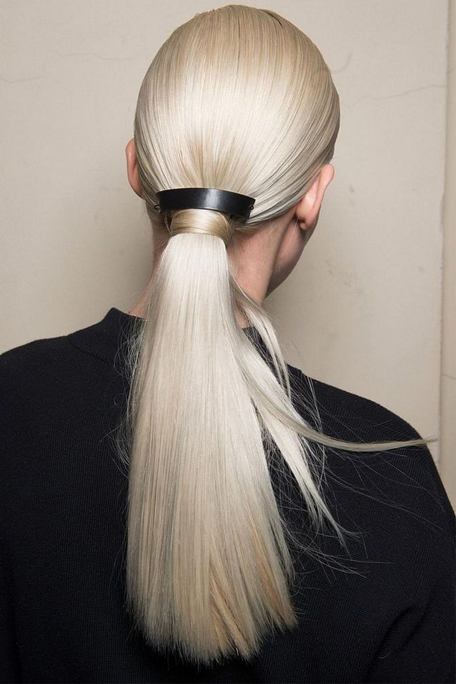 The ponytails at Aigner were pulled tight, had the elastics hidden by a strand of hair, and then topped with a leather barrette that added to the sculptural vibe.