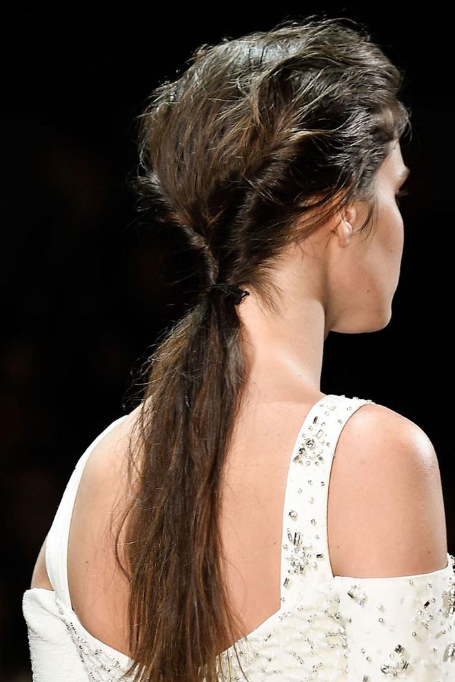 The hair was twisted into a low ponytail and given plenty of texture.