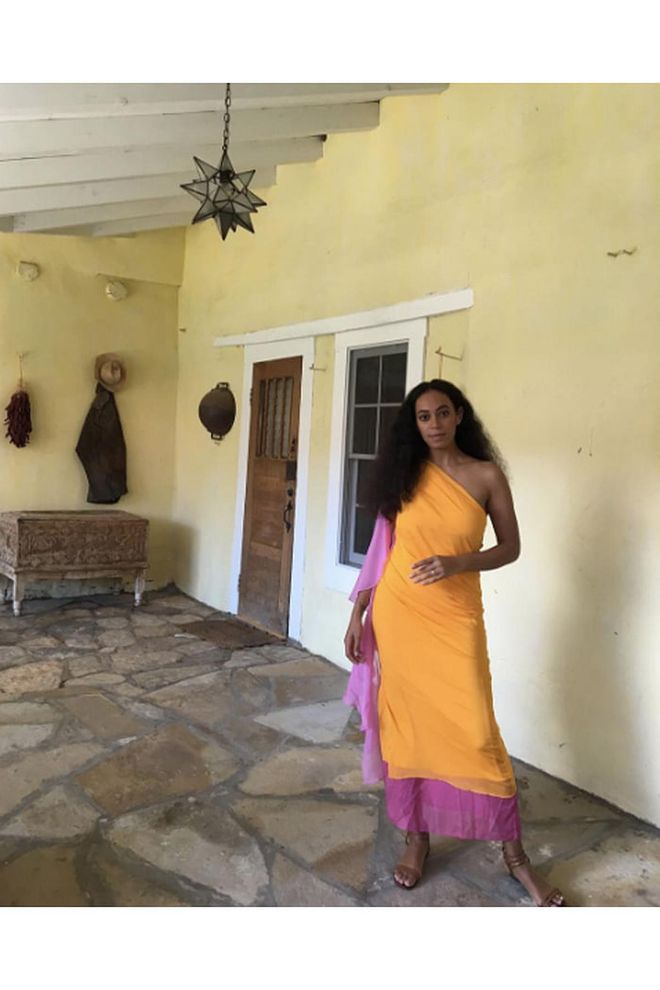 Solange poses in an orange and pink one-shouldered dress at a vacation home in New Mexico.
—@saintrecords Photo: Instagram