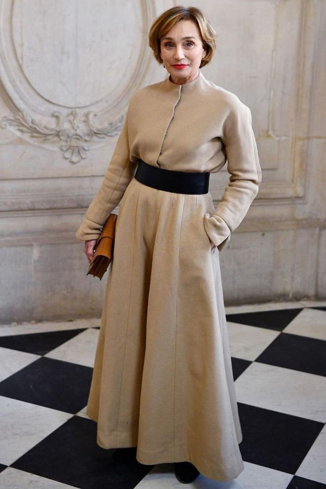 Kristen Scott Thomas looked chic in a camel coat dress with a wide waist-cinching belt.