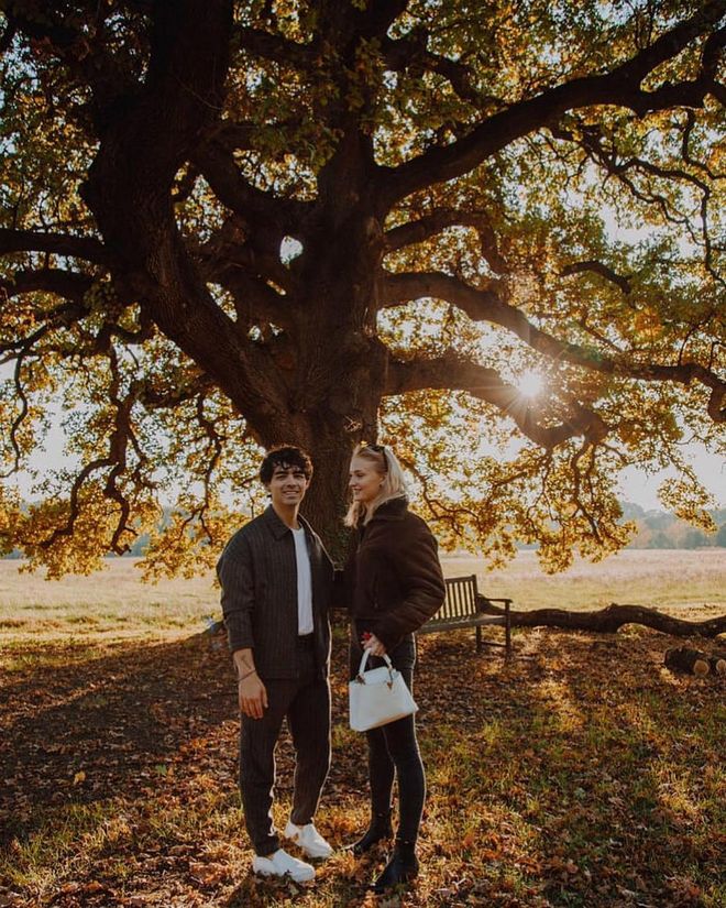 The Game of Thrones star and husband Joe Jonas wore a matching color palette of moss green, white, and black that perfectly complements the glowing sunset and rich foliage that surrounds them.