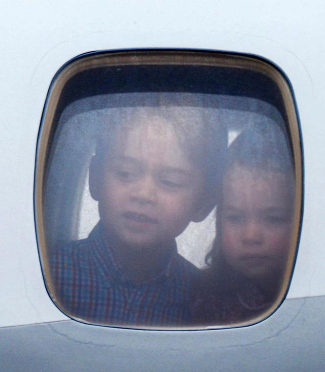 Prince George and Princess Charlotte peeked out their plane window as the royals arrived for their tour of Germany and Poland.
Photo: Getty 
