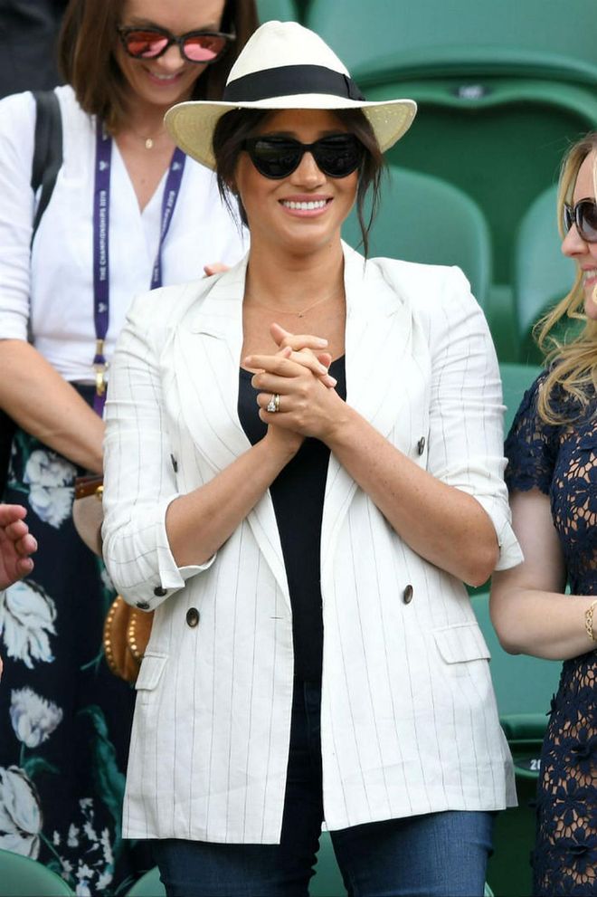 The Duchess of Sussex was spotted cheering on her close friend Serena Williams on the stands at Wimbledon, wearing a pinstripe L'Agence blazer, slim-fit jeans and classic courts. She accessorised with sunglasses, a straw hat and a Jennifer Meyer gold necklace adorned with the letter 'A' in the middle as a sweet tribute to her newborn son.