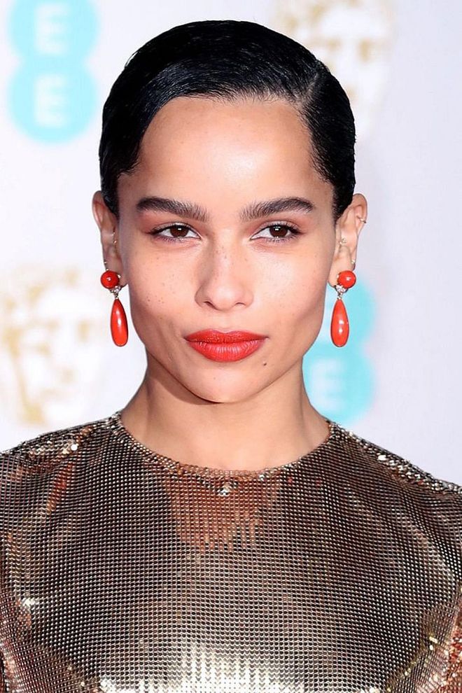 Zoe Kravitz matched her lipstick to her accessories, choosing an orange-toned rouge that added warmth to her skin tone.

Photo: Getty