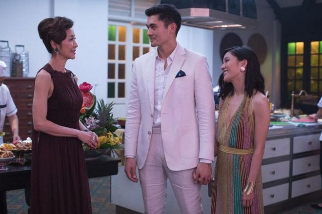 Eleanor Young (Michelle Yeoh) is the mother of Nick Young. She’s all understated elegance in this floor-length plum gown. It conveys the fact that she’s a traditional woman, but one who embodies total sophistication.