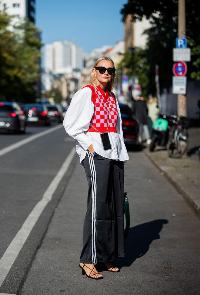 BERLIN, GERMANY - SEPTEMBER 14: Pauline Riemis wearing Adidas track suit pants, red checkered slipover, white button shirt seen during About You Fashion Week on September 14, 2021 in Berlin, Germany. (Photo by Christian Vierig/Getty Images)