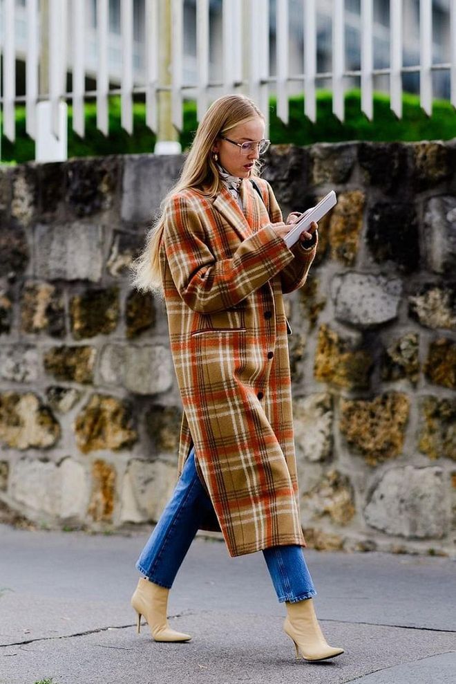 A longline plaid coat looks extra chic when worn with neutral, matching booties. Photo: Tyler Joe