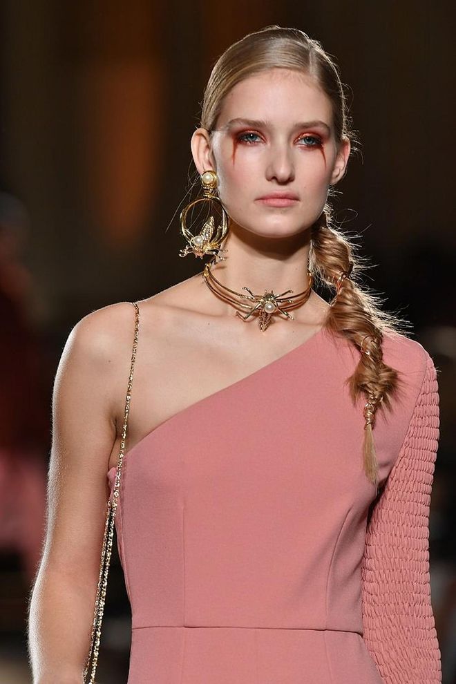 Christian Siriano's show had models looking like "Victorian Techno Goths" with dripping eyeshadows in a bold reddish copper shade.  This bold look is paired unexpectedly with wispy fishtail braids creating a intended juxtaposition as bits of copper is strung through the fishtail braids to tie the look together. Photo: Getty 