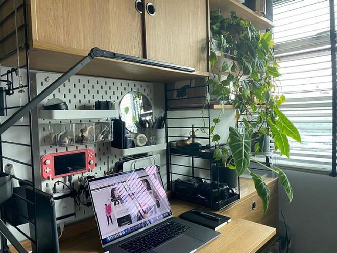 I love being organised, so the pegboard on the wall serves as a charging station for my electronics and also keeps everything off the surface of my very small desk. I also love being surrounded by plants so the green wall shelf beside me keeps my mood uplifted. 