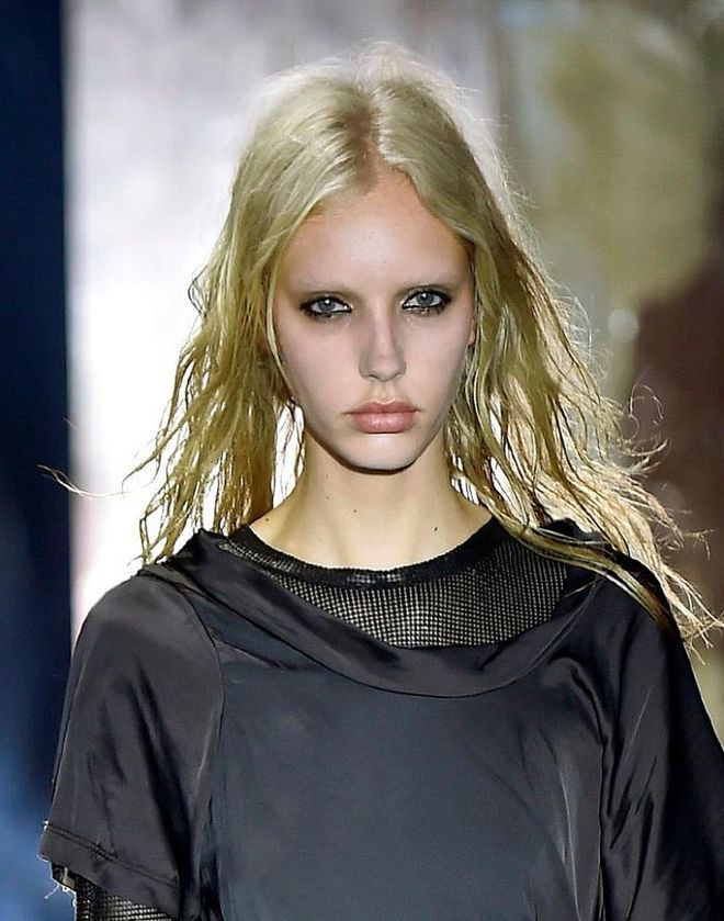 Punk rock party girls walked the Alexander Wang runway. The look embraces imperfection as the models' eyes are smudged heavily with black kohl. Their kohl-rimmed eyes are matched with tousled, messy hair (almost stringy) to create that "after-party" look. Photo: Getty