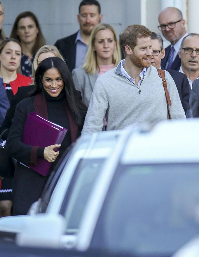 Meghan Markle arrived in Australia looking incredibly fresh in a chic coat was worn over tapered black pants, and a black sweater. 
