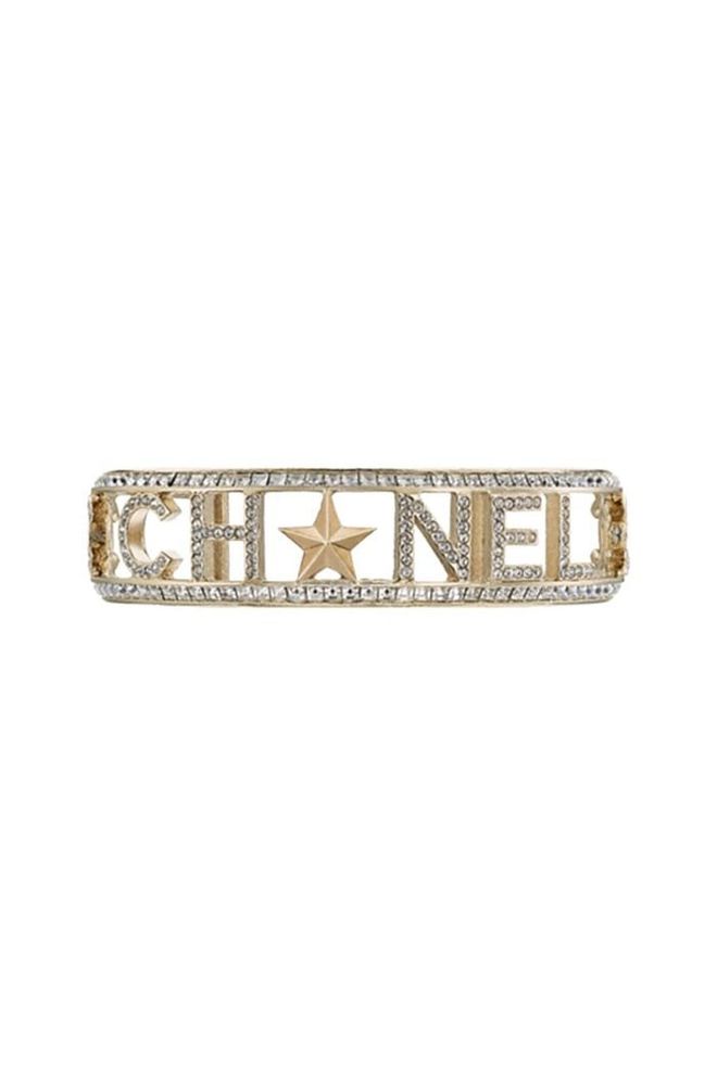 Add a bit of vintage glamour to your outfit with Chanel's metal star bracelet. 