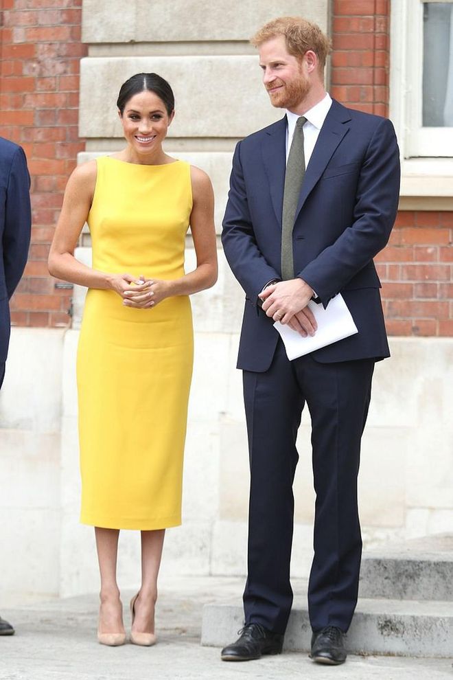 The Duchess of Sussex channelled 'Amal Clooney', looking pared back yet bold in her canary yellow Brandon Maxwell boat neck dress that hugs at all the right places. She kept it simple with no jewellery, save for a single stud and nude Manolos. 