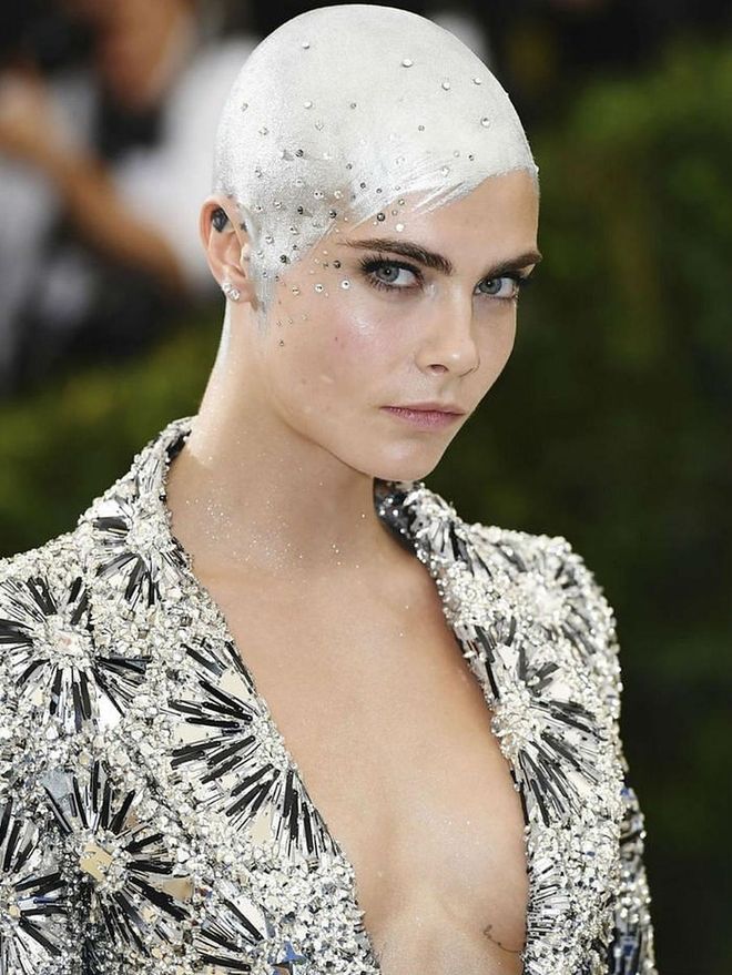 Cara Delevingne blew our minds with her ingenious hairstyles this year—considering she had almost no hair for more than half of it. Our favorite look? The silver painted and bedazzled scalp at the 2017 Met Gala. No hair, no problem.