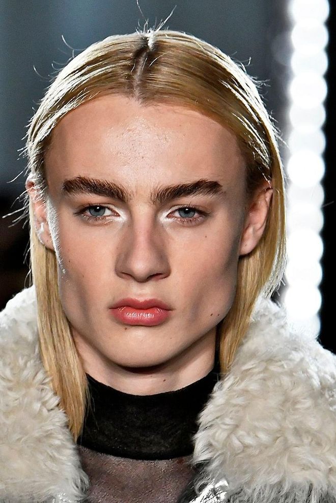 Makeup artist, Diane Kendal created a dewy and fresh complexion by only covering imperfections with small amounts of concealer and leaving the rest of the skin bare. Brows are brushed up and lips are kept natural with just lipbalm. Some models had white eyeliner placed on the the inner corners of their eyes, creating a bright-eyed effect. Photo: Getty  