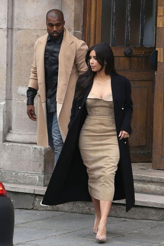  Just days before their wedding, Kim and Kanye step out in coordinating camel—Kim in an Ermanno Scervino bustier dress, Kanye in a matching coat. Photo: Getty