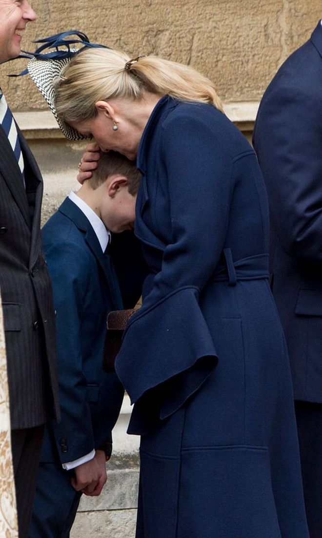 Prince Edward's wife hugs their son, James Viscount Severn, outside of St. George's Chapel.

Photo: Getty