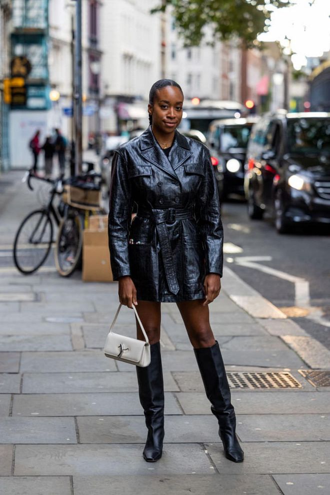 LONDON, ENGLAND - SEPTEMBER 18: Chrissy Rutherford wears black belted vinyl jacket, black knee high boots outside Erdem during London Fashion Week September 2022 on September 18, 2022 in London, England. (Photo by Christian Vierig/Getty Images)