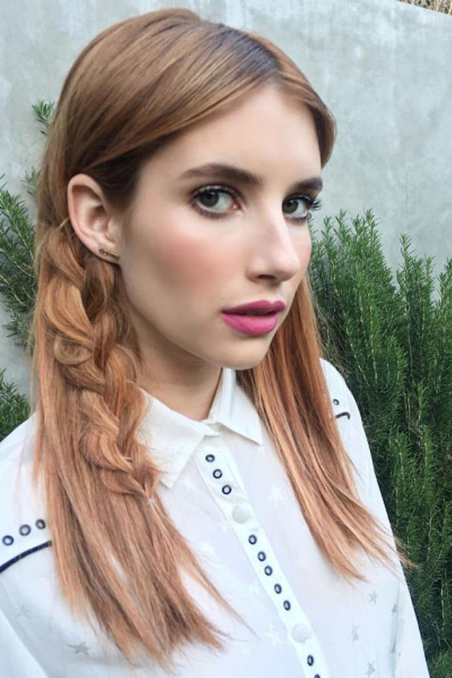 Hairstylist Riawna Capri sneakily worked a statement braid into Emma Robert's strawberry strands for Coachella by taking a chunk of hair, braiding it from the mids-to-ends only, then pancaking it so that it lays flat. Worn tucked behind the ear, it's the perfect way to ensure the plait stays in place—and it just looks cool.