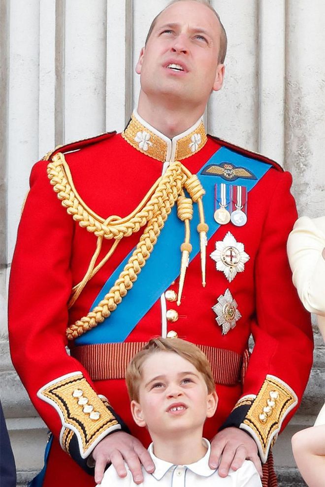 Prince William places his hands on George's shoulders as they look up at the flypast during Trooping the Colour.

Photo: Getty