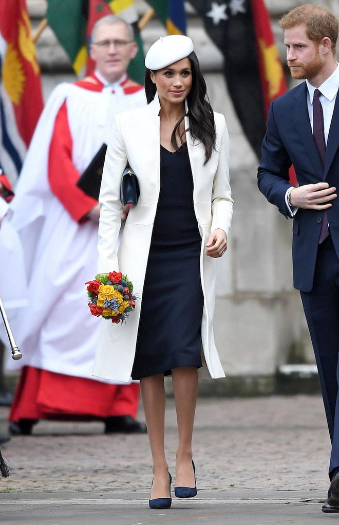 Meghan was dressed head-to-toe in British brands for the Commonwealth Service. Her cream coloured coat and black tailored midi dress underneath are by British designer, Amanda Wakeley. She also carried a little navy Mulberry clutch and matching Manolo pumps. Her beret by Stephen Jones was a little ode to Princess Diana and is a really nice touch. 