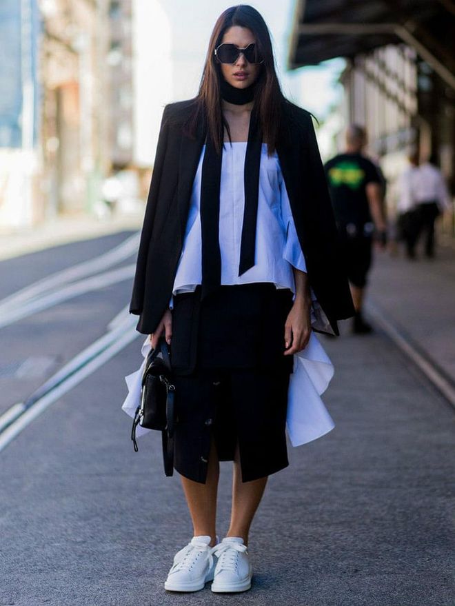 For a sophisticated spin, style your sneaks with structured office-friendly pieces like an oversized blazer and black pencil skirt.