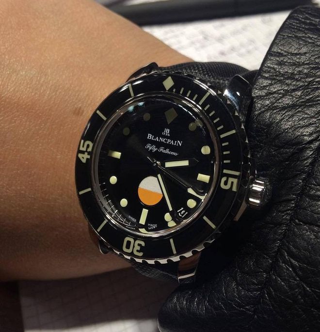 The white and orange dot you see on the Fifty Fathom MIL-SPEC's dial is a indicator that lets you know if water has seeped into your watch (it changes colour if it has)