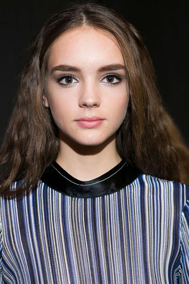 The Look: A Beautiful Tribute
How-To: The spring 2017 Sonia Rykiel collection was the first since the designer passed away in August of this year. Both makeup artist Lisa Eldridge and hairstylist Paul Hanlon paid beautiful tributes to Rykiel through the show's beauty look. Eldridge used a navy eyeshadow shade from the Lancôme Saint-Germain palette (which was part of a capsule collection the beauty brand did with Rykiel) to create a smudgy eyeliner look reminiscent of one the designer preferred. Hanlon whipped the models' hair into fuzzy,'70s-inspired waves by curling ad backcombing the hair. On red-headed models, the reference to Rykiel was undeniable. But on all the others, the hairstyle was merely a little wink and reminder that the designer's personal style will live on.