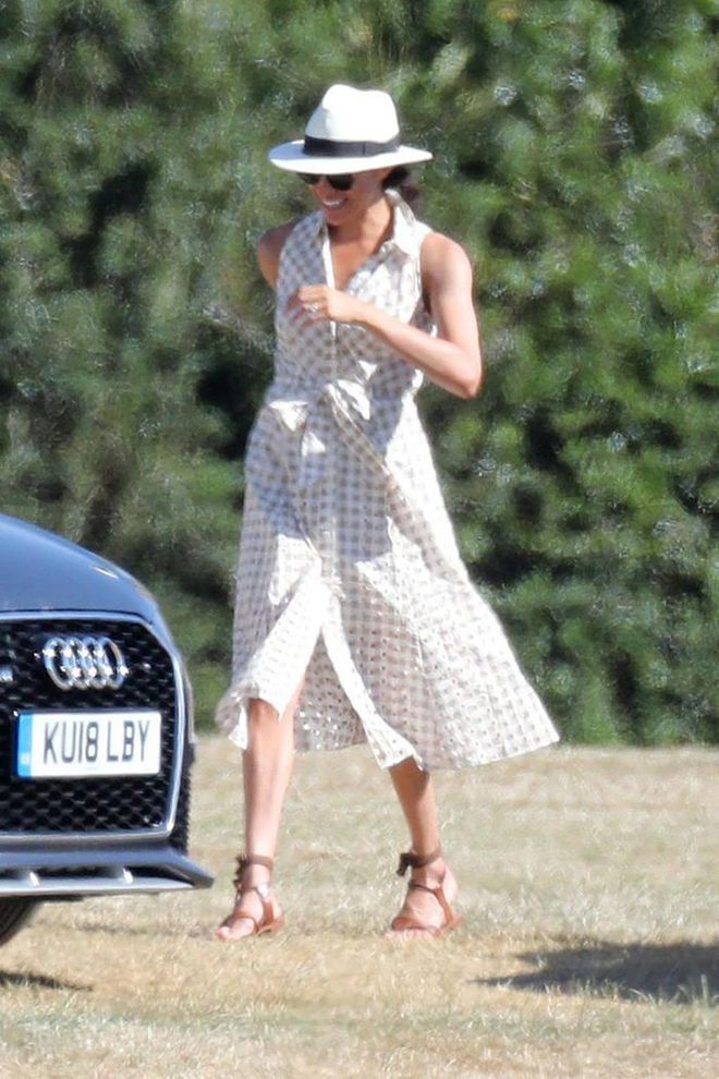 Meghan had a 'Pretty Woman' moment with this beige gingham dress from Shosanna topped with a white panama hat. Looking carefree (perhaps even breaking a royal protocol) with her Sarah Flint lopen-toe sandals.  