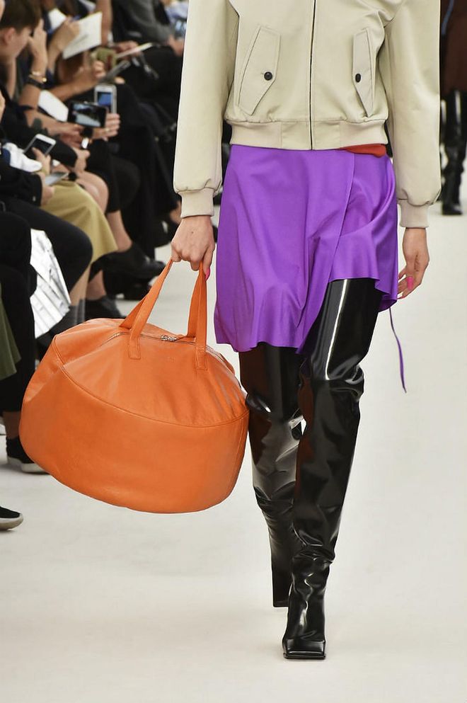 Seen at: Paris Fashion Week//Why we love it:  A beanbag-shaped bag in tangerine leather may seem simplistic, but its unusual approach to a carryall is precisely why this offering from Balenciaga is a stand out piece. (Photo: Getty) 