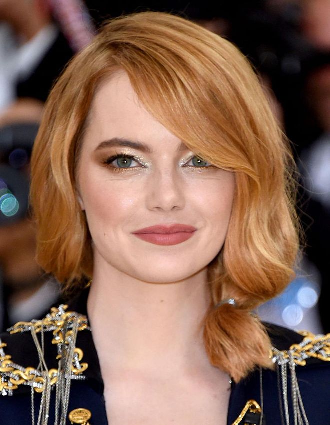 Emma Stone attended the Met Gala this year wearing a matte coral lipstick—beautiful on any bride—with an edgy metallic bronze-and-silver smoky eye. It's an unexpected take on a classic bridal makeup look.

Photo: Getty
