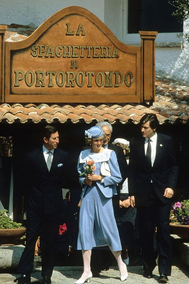 Wearing a blue Jan van Velden suit and John Boyd hat while visiting Sardinia, Italy with Prince Charles. Photo: Getty