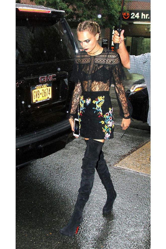 Cara Delevingne in a sheer lace Zuhair Murad top, floral mini and suede over-the-knee Louboutins while out in New York. Photo: Splash