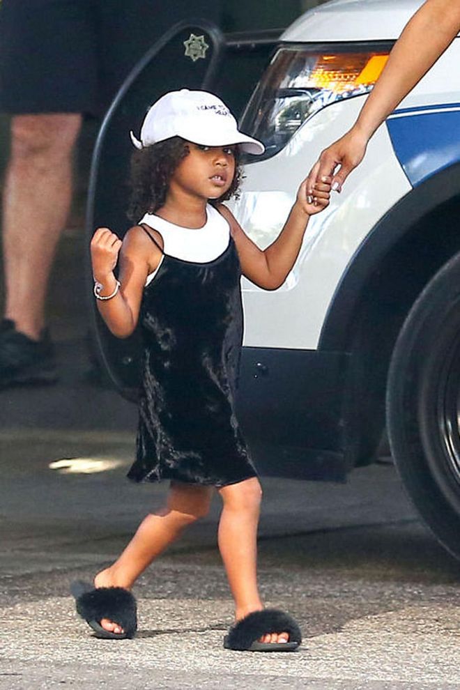 While out in Miami, North embraced the furry slides trend, styling a black pair by AKID with a velvet slip dress, t-shirt and dad hat—looking insanely cooler than any of us ever will. 