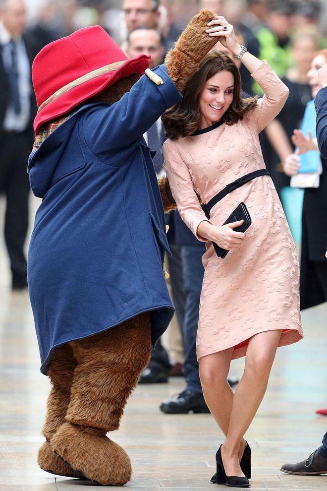 Duchess Kate dances with Paddington Bear as she arrives at the Charities Forum Event at Paddington Station with Prince William.
Photo: Getty