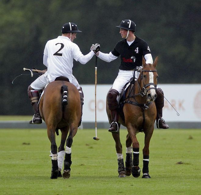 Will and Harry shake hands from their horses as they play in the Sentebale Polo Cup in Ascot.
Photo: Getty 
