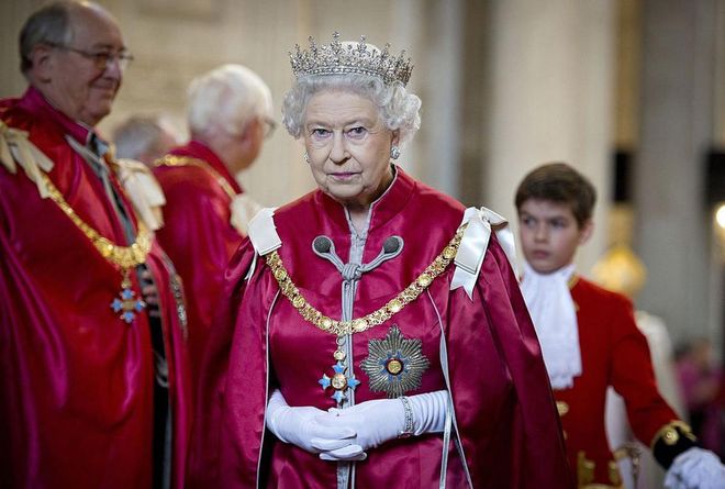 You stand. Everyone in the Queens' presence is required to rise when the Queen is standing, or when she enters or exits a room.
Photo: Getty